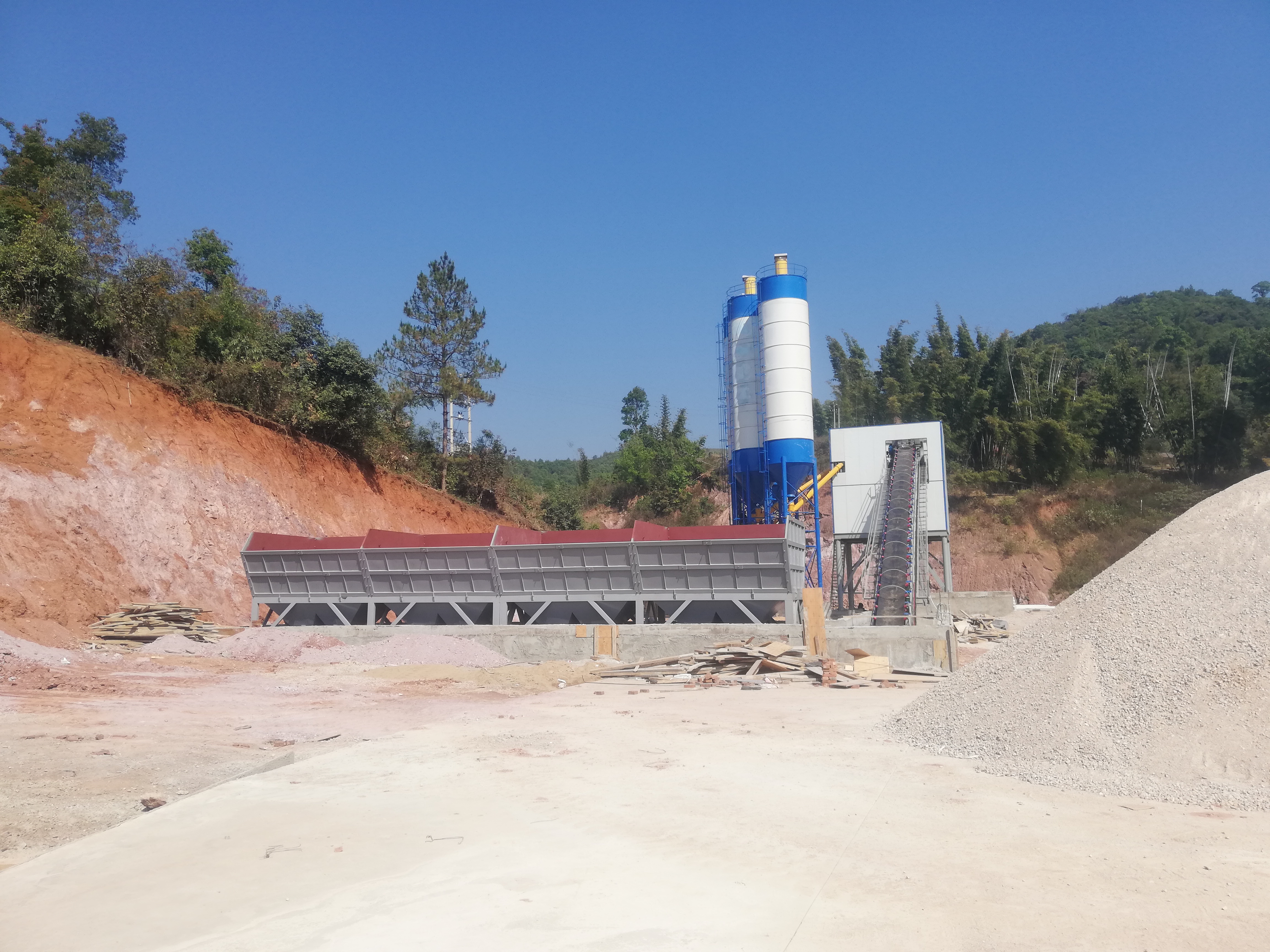 Stationary concrete batching plant installed at an aggregate production site