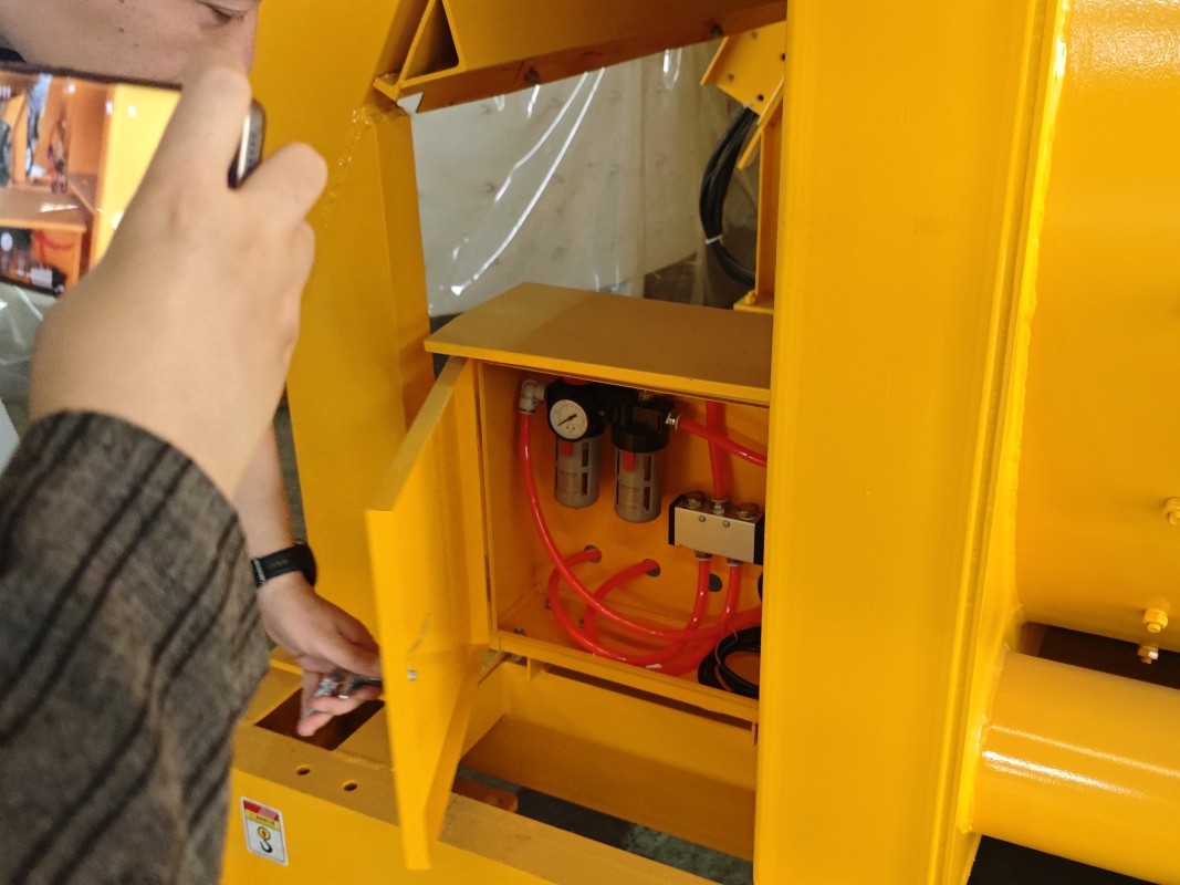 Technician inspecting the pneumatic system of batching equipment
